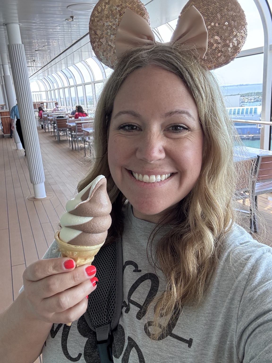 Amber smiling on a cruise deck holding an ice cream cone